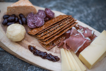 Butter board with cultured butter, cheese, crackers, meats, jams, and more